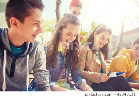 group of students with notebooks at school yard group of students with notebooks at school yard 42340131