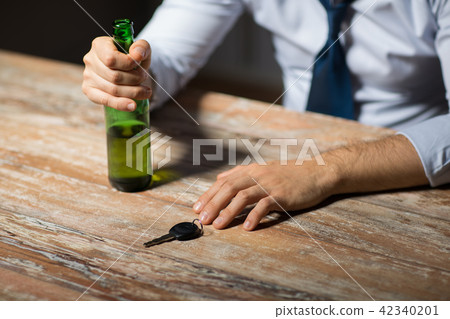 close up of hands with alcohol and car key close up of hands with alcohol and car key 42340201