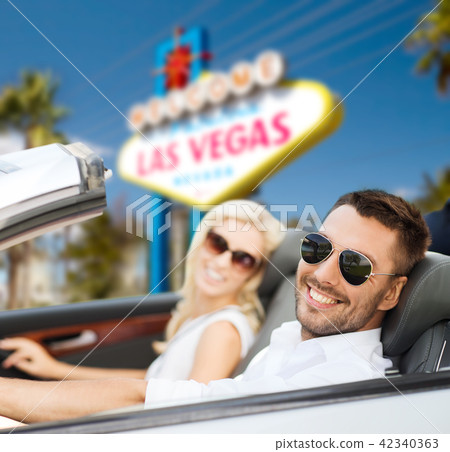 couple driving in convertible car at las vegas 42340363