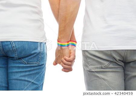 male couple with gay pride rainbow wristbands 42340459