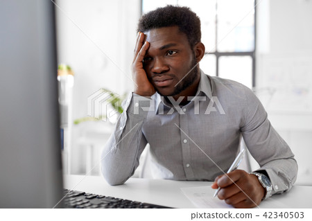 businessman with computer and papers at office businessman with computer and papers at office 42340503