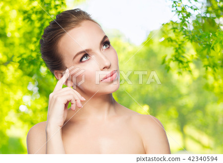 beautiful young woman touching her face 42340594