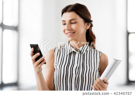 businesswoman with smartphone and folder at office businesswoman with smartphone and folder at office 42340787