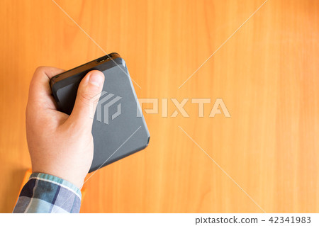 Man holds an external hard drive Man holds an external hard drive 42341983