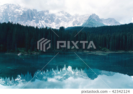 The Karersee lake with reflection of mountains in the Dolomites. The Karersee lake with reflection of mountains in the Dolomites. 42342124