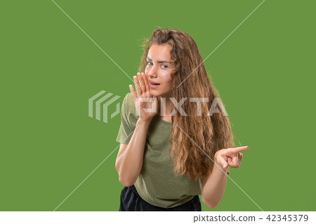 The young woman whispering a secret behind her hand The young woman whispering a secret behind her hand 42345379