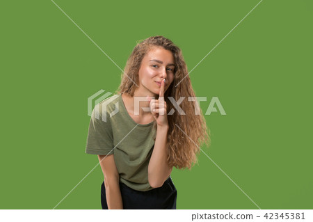 The young woman whispering a secret behind her hand The young woman whispering a secret behind her hand 42345381