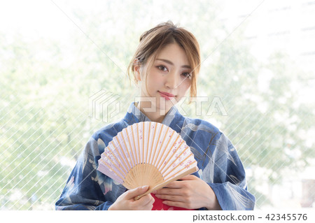 A woman with a fan 42345576