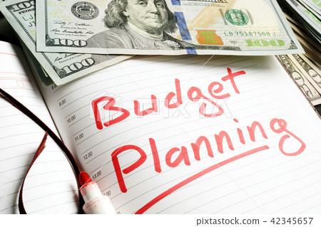 Budget Planning handwritten in a note and money. 42345657