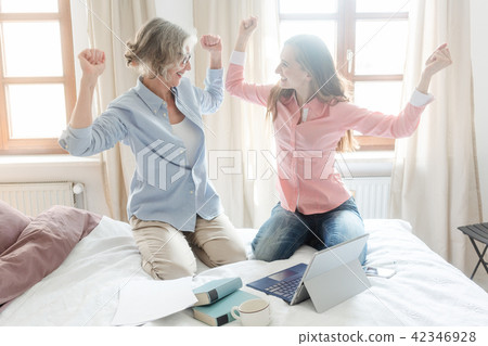 Mother and daughter working together giving high-five 42346928