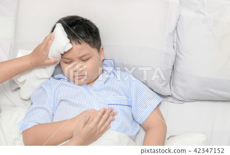Sick child with fever and illness in bed, top view Sick child with fever and illness in bed, top view 42347152