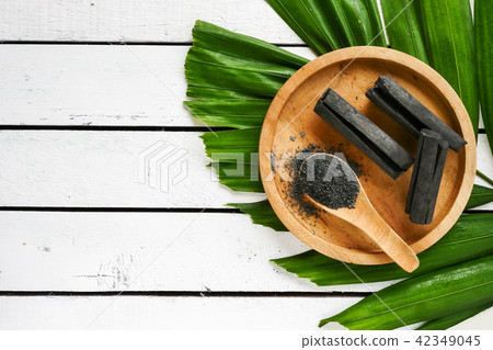 Bamboo charcoal and powder on wooden table. 42349045