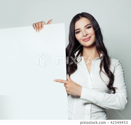 Smiling business woman holding white blank paper 42349453