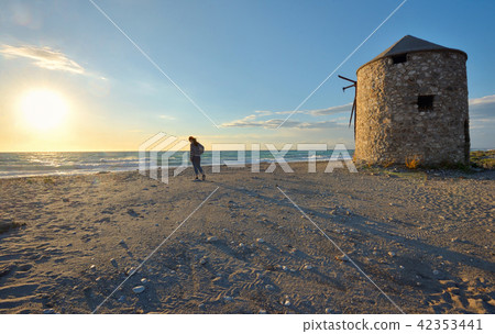 Young girl on the sunset beach 42353441