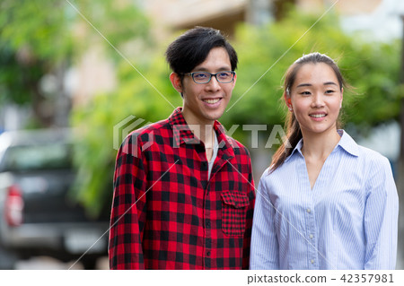 Young happy Asian couple together outdoors 42357981