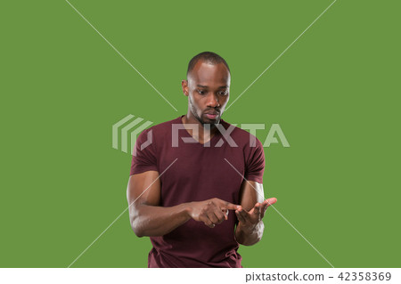 Beautiful male half-length portrait isolated on green studio backgroud. The young emotional Beautiful male half-length portrait isolated on green studio backgroud. The young emotional 42358369