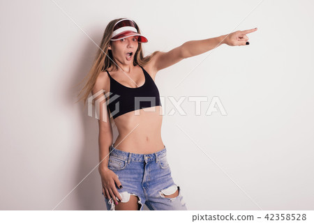 Mischievous girl amazement points a finger Mischievous girl amazement points a finger 42358528