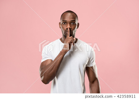 The young man whispering a secret behind her hand 42358911