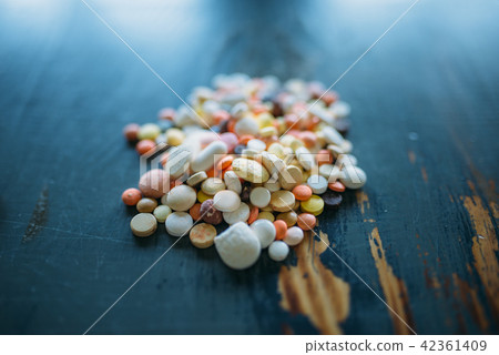A lot of drugs and pills on wooden table closeup 42361409