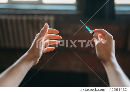 Junkie hands with syringe, drug addiction concept 42361482
