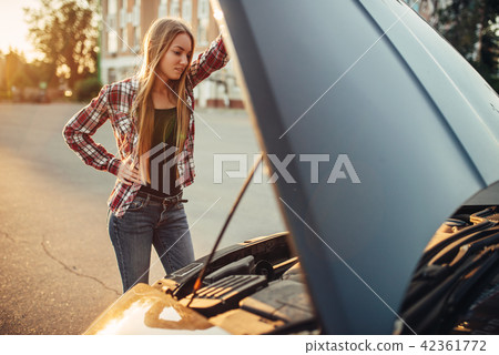 Car breakdown concept, woman against open hood Car breakdown concept, woman against open hood 42361772