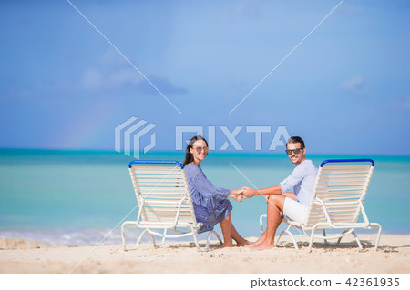 Couple relax on a tropical beach at Maldives Couple relax on a tropical beach at Maldives 42361935