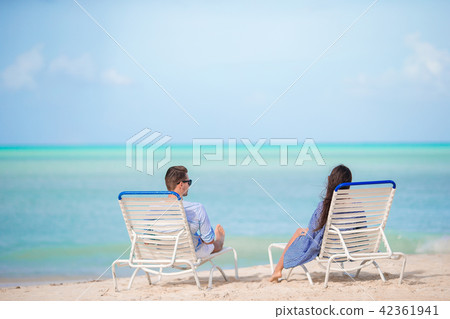 Couple relax on a tropical beach at Maldives Couple relax on a tropical beach at Maldives 42361941