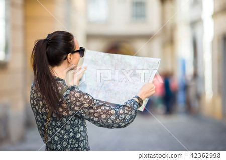 Young woman with a city map in city. Travel tourist girl with map in Vienna outdoors during holidays 42362998