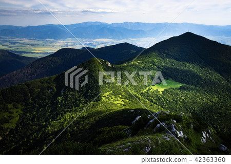 view of the valley on a mountain green saddle 42363360