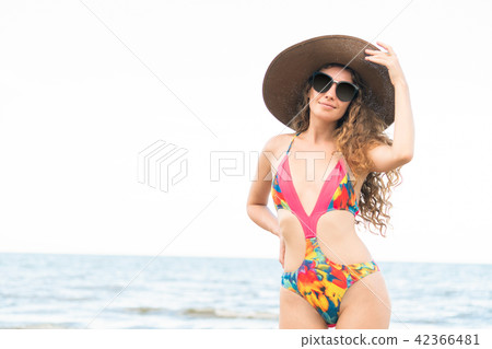 Happy young woman at beach in summer vacation. Happy young woman at beach in summer vacation. 42366481