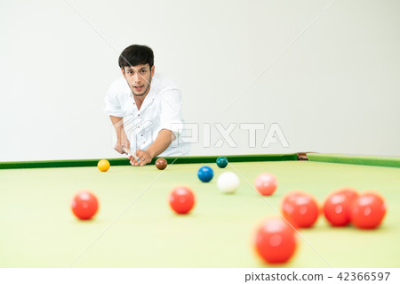 Young man playing snooker in the club. Young man playing snooker in the club. 42366597