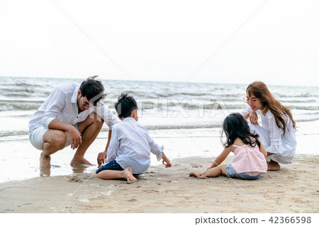 Happy family goes vacation on the beach in summer. 42366598