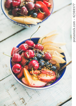 Healthy smoothie bowl with fruit and berries over wooden background 42369377