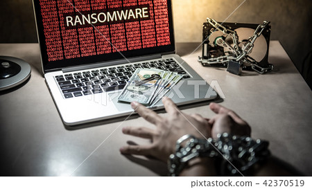 Locked hands and ransomware cyber attack on laptop 42370519