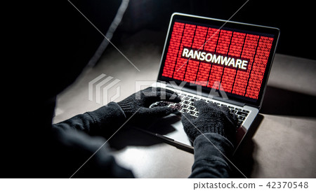 Hacker hand on laptop, ransomware attack screen Hacker hand on laptop, ransomware attack screen 42370548