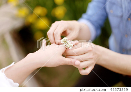 A man putting on a flower gift 42373239