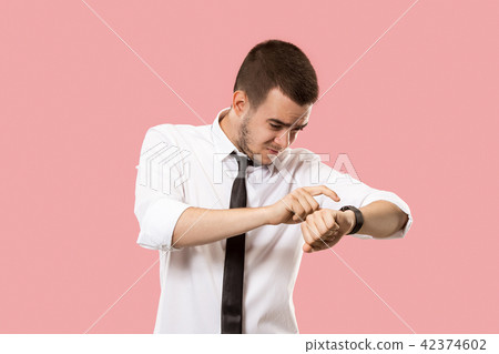 Handsome businessman checking his wrist-watch Isolated on pink background Handsome businessman checking his wrist-watch Isolated on pink background 42374602