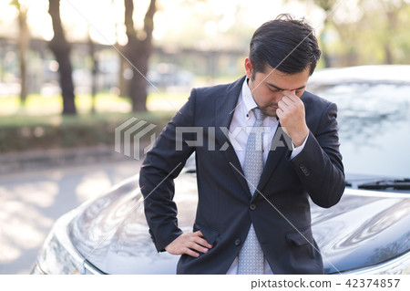 Businessman feel headache near his broken down car 42374857
