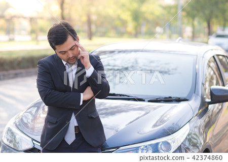 Businessman feel headache near his broken down car 42374860