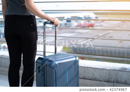 Young woman with suitcase in airtport Young woman with suitcase in airtport 42374967