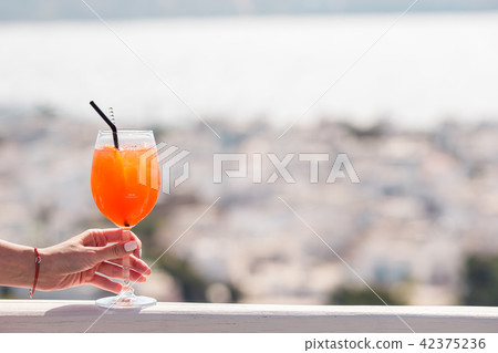 Closeup glass with alcohol drink background in beautiful old Mykonos Closeup glass with alcohol drink background in beautiful old Mykonos 42375236