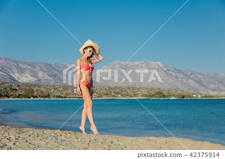 girl in hat and bikini on Elafonissi beach 42375914