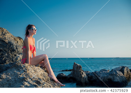 girl in hat and bikini on Elafonissi rock beach 42375929