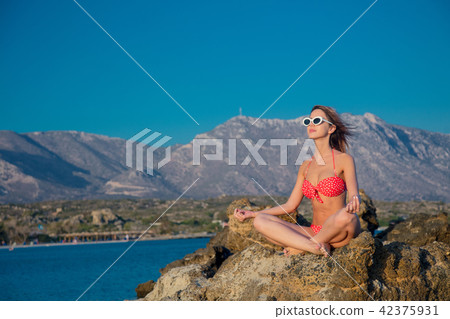 girl in sunglasses and bikini on Elafonissi beach 42375931