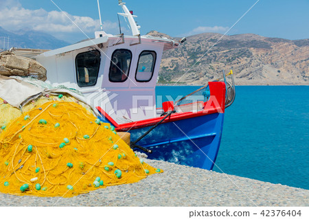 fishnet and boat in a port of Agia Galini fishnet and boat in a port of Agia Galini 42376404