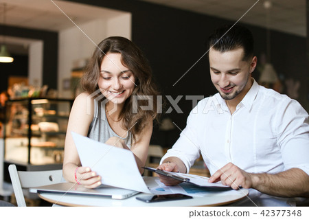 Young happy businesswoman working documents and talking with boss. 42377348
