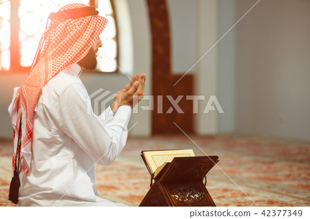 Religious muslim man praying inside the mosque 42377349