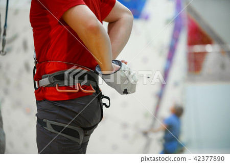 Close-up photo of man climber with talc bag in gym Close-up photo of man climber with talc bag in gym 42377890