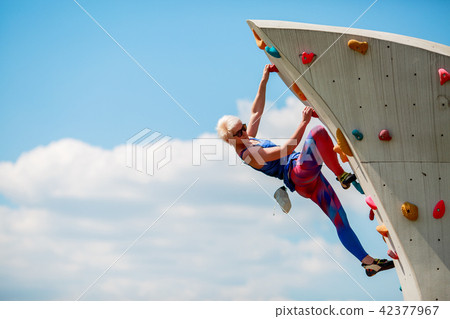 Photo of young sportive woman clambering on rocky summer day Photo of young sportive woman clambering on rocky summer day 42377967