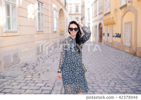 Woman walking in city. Young attractive tourist outdoors in european city Woman walking in city. Young attractive tourist outdoors in european city 42378048